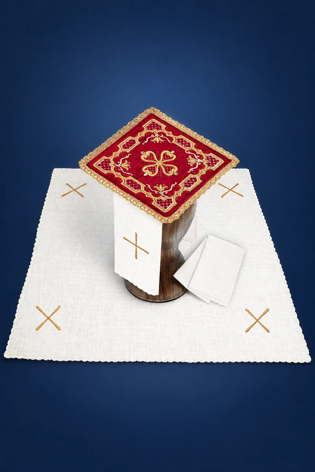Embroidered red velvet altar linen set with gold cross motifs, shown laid out with a central square cover and folded cloths.