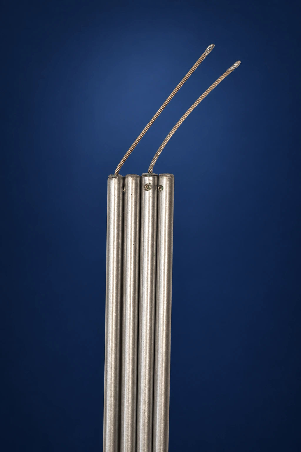 Four vertical metal canopy frame poles with two braided ropes extending from the top, front view