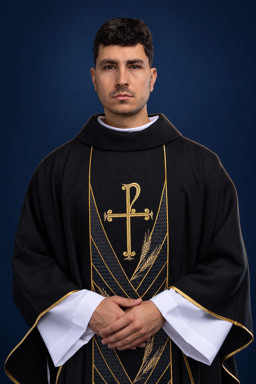 Front view of a black chasuble with gold PAX cross and diagonal embroidered orphrey