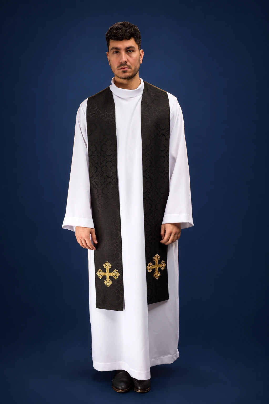 Front view of a black jacquard stole with gold cross embroidery at the ends, worn over a white alb