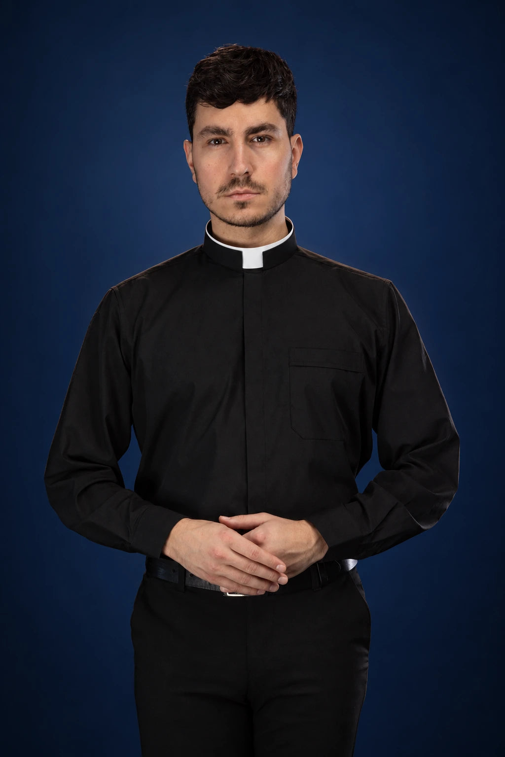 Front view of a black Roman clergy shirt with long sleeves and a white clerical collar
