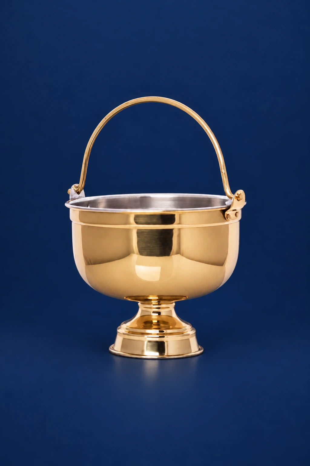Front view of a brass holy water bucket with hinged handle and polished pedestal base