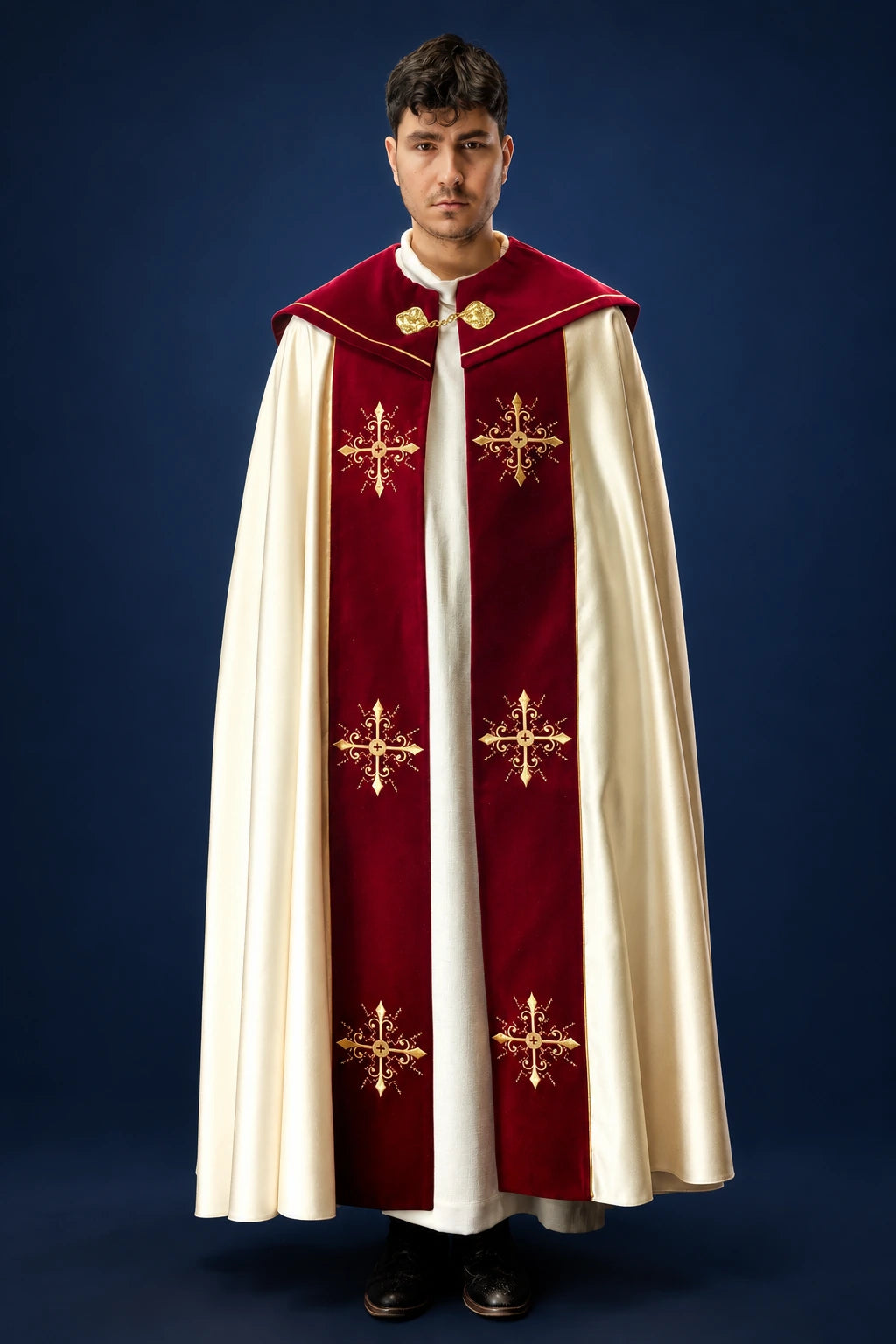 Front view of a burgundy and ivory cope with gold embroidered crosses and clasp at the neck