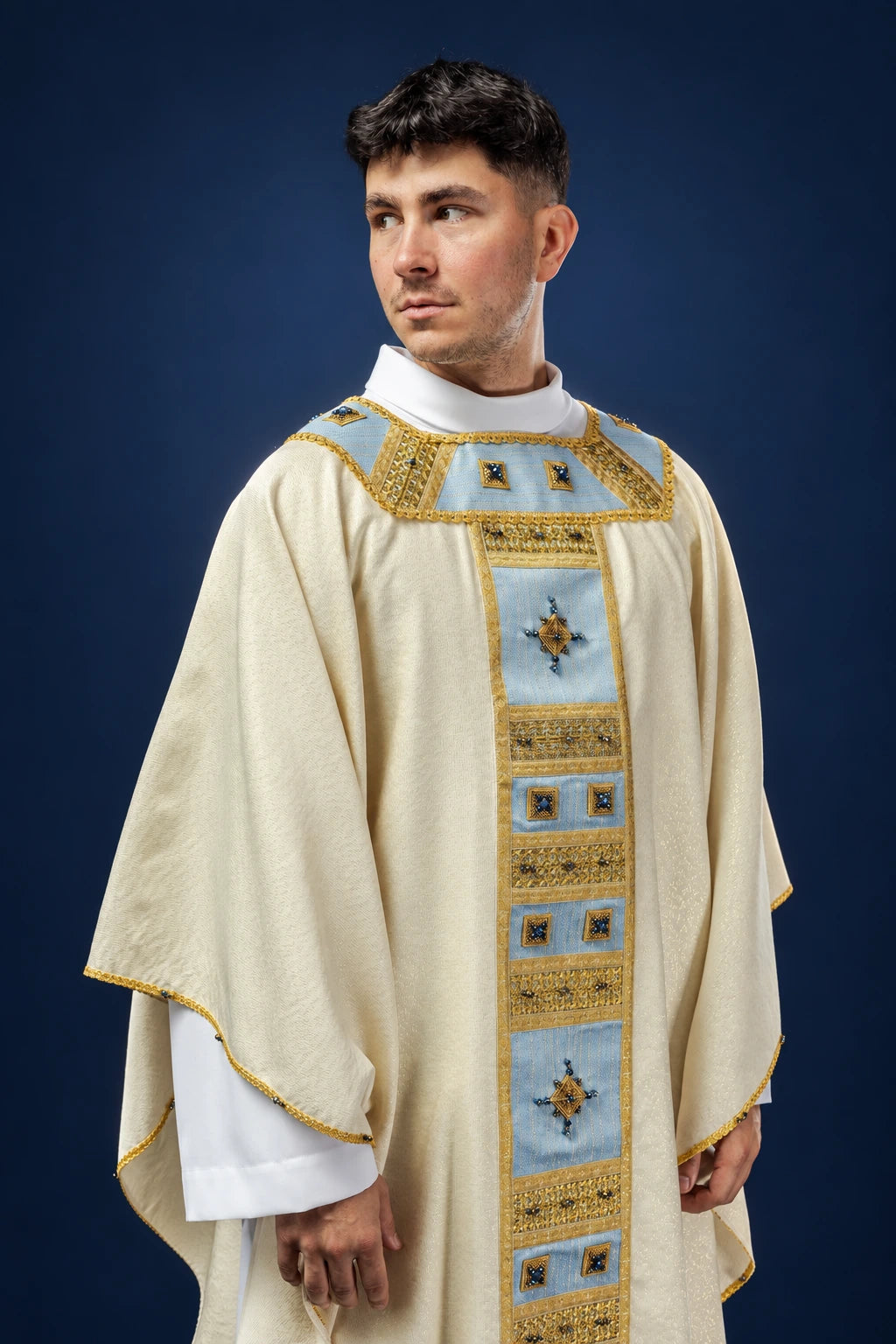 Front view of cream chasuble with blue Marian orphrey and gold trim