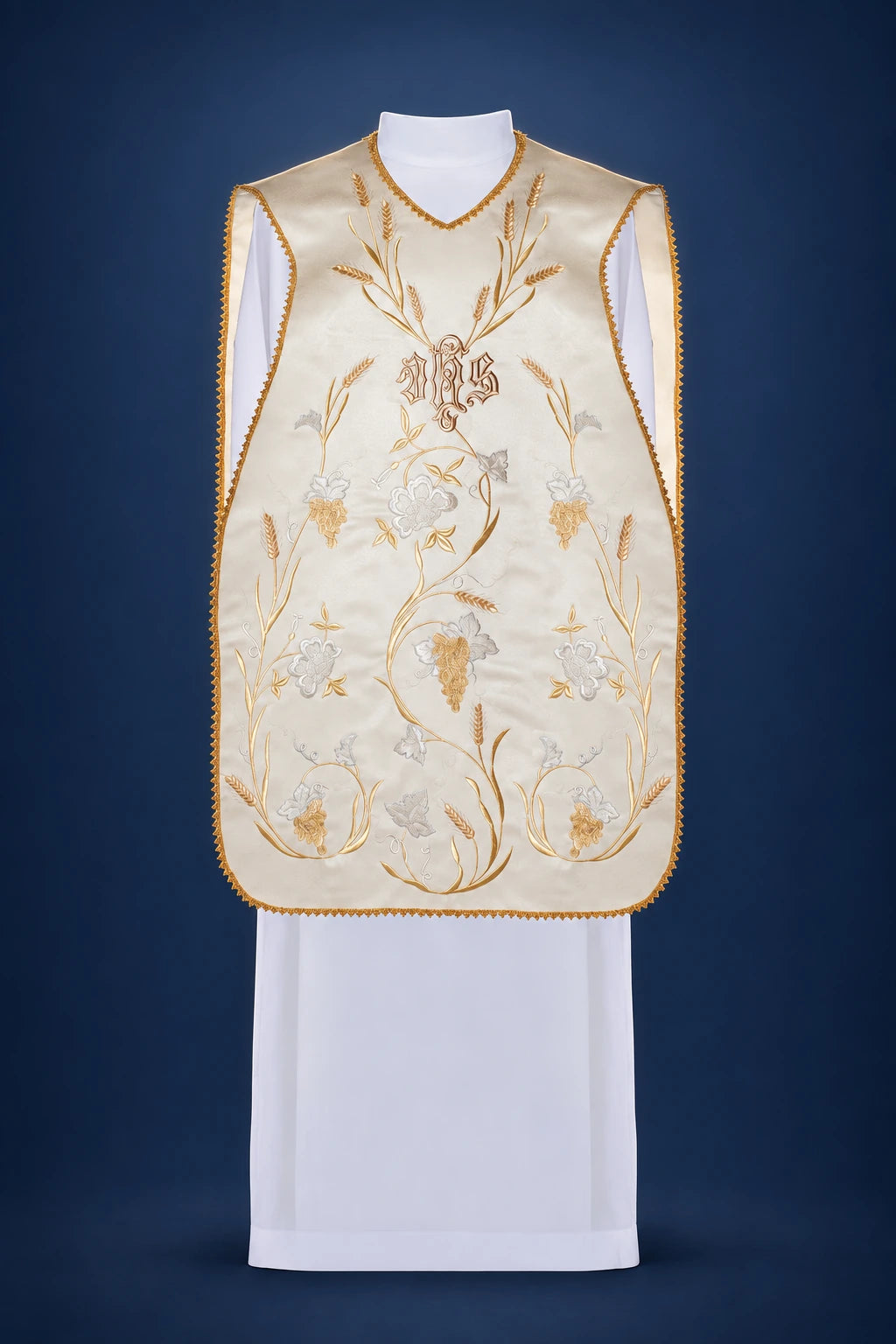 Front view of a cream chasuble with gold IHS, wheat, and grape embroidery and gold trim