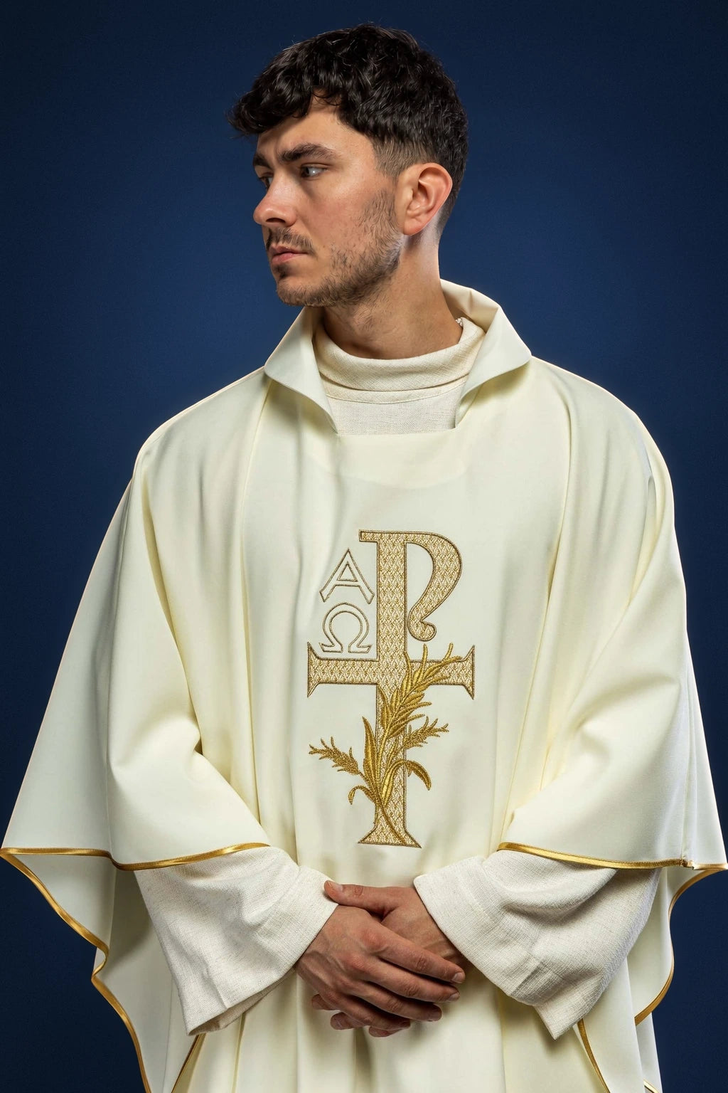 Front view of cream chasuble with wide ecru collar and embroidered Alpha Omega cross motif