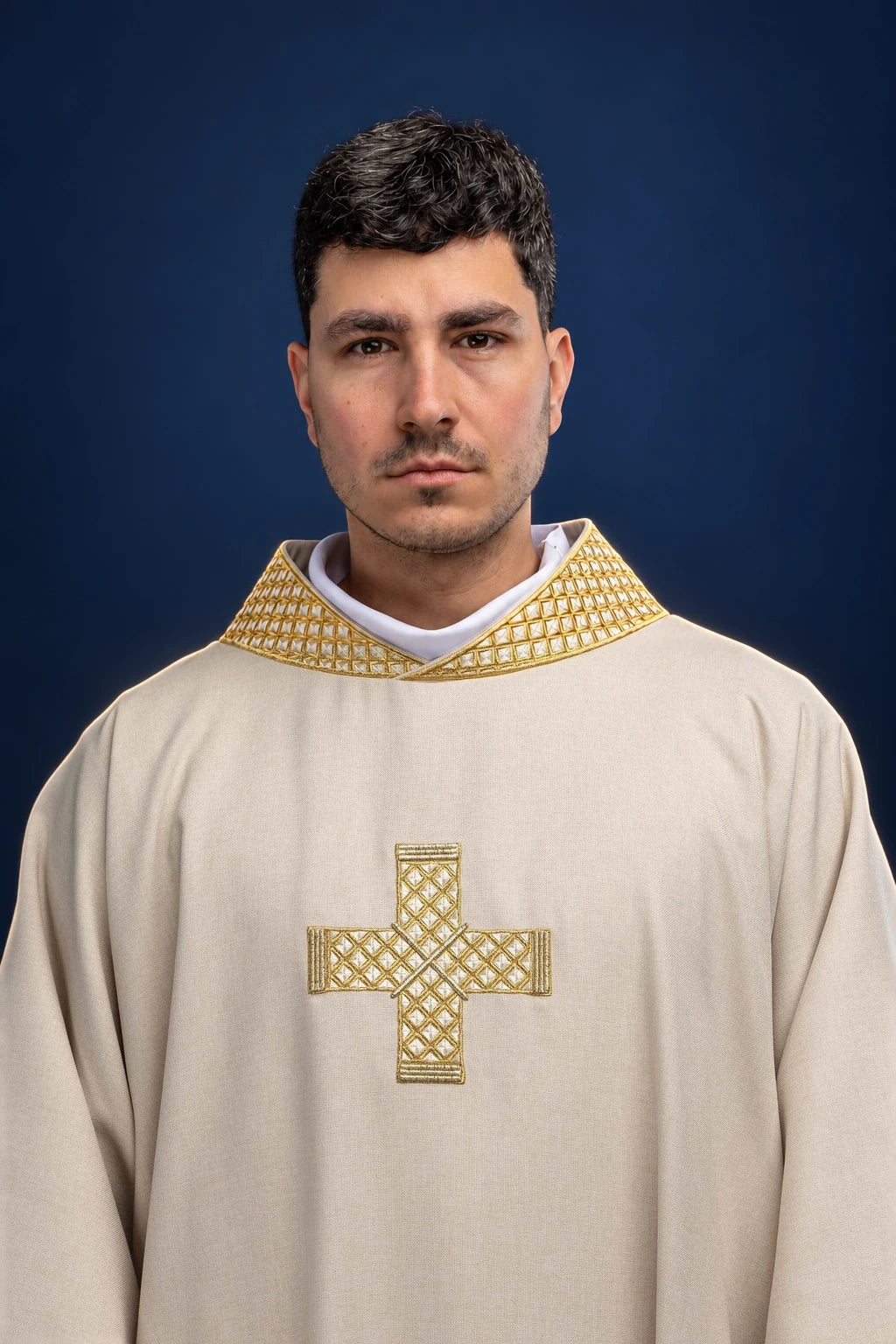 Front view of a cream dalmatic with gold embroidered cross and ecru patterned collar