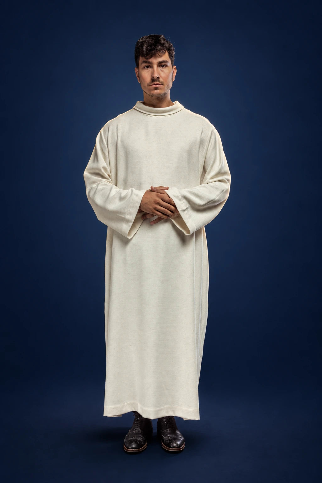 Front view of a cream linen priest alb with loose sleeves and a simple round neckline