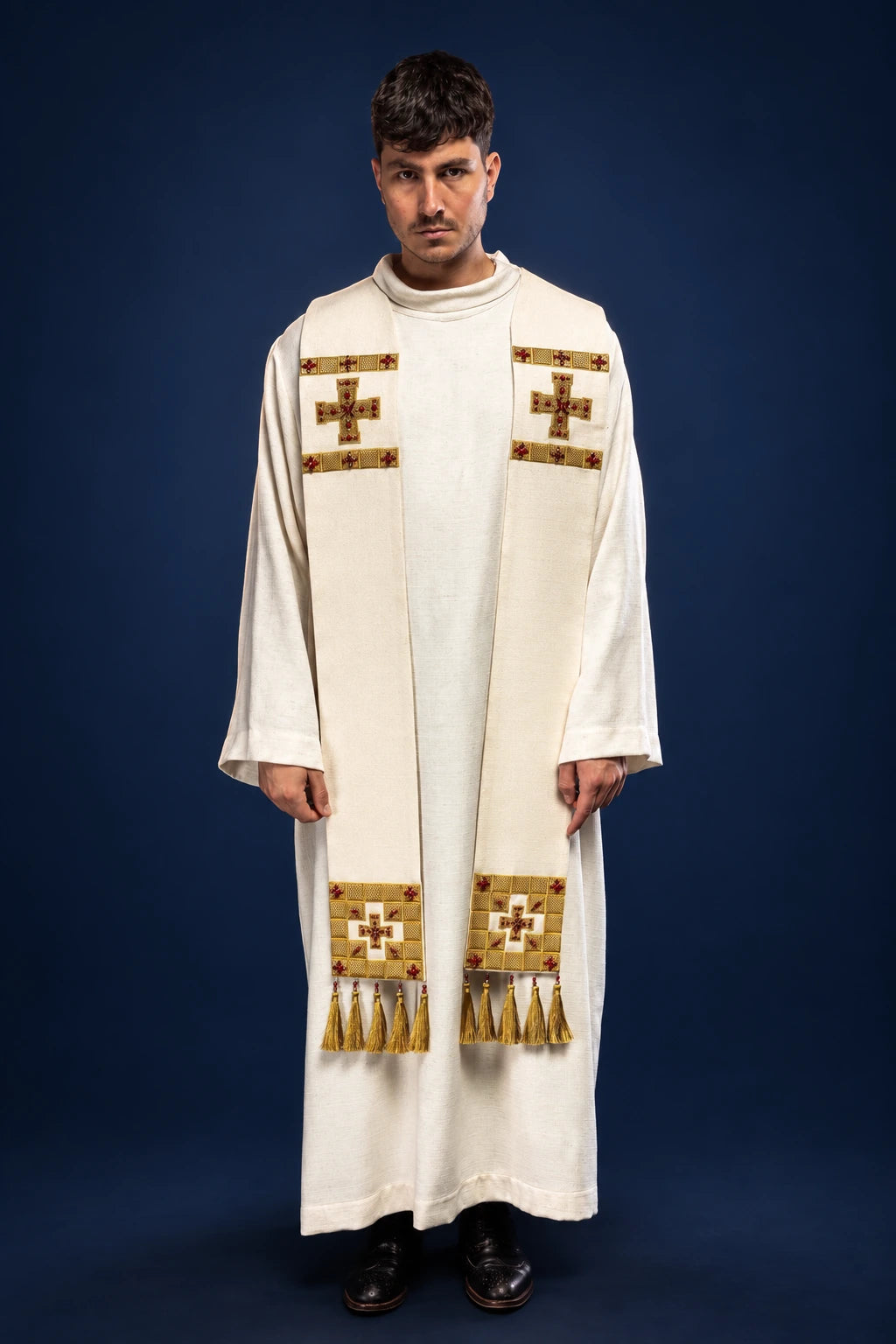 Front view of a cream liturgical stole with stone-like cross appliqués and fringe at the ends