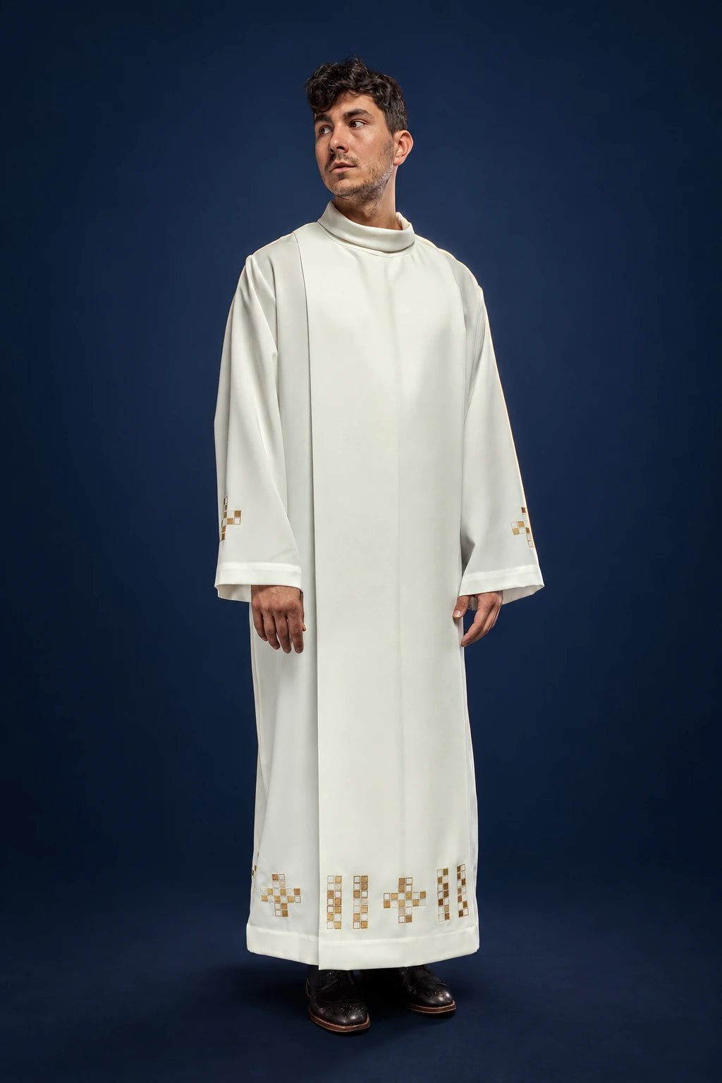 Front view of an ecru alb with embroidered mosaic crosses at the hem and cuffs