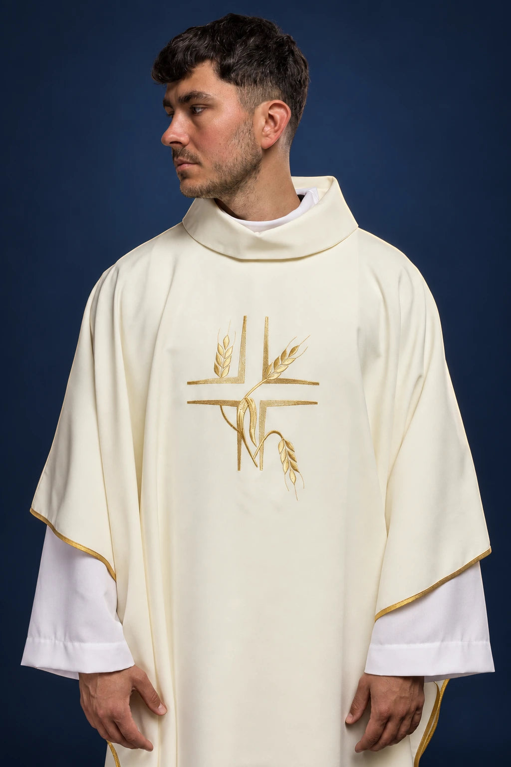 Front view of an ecru chasuble with gold cross and wheat embroidery, gold trim, and high collar