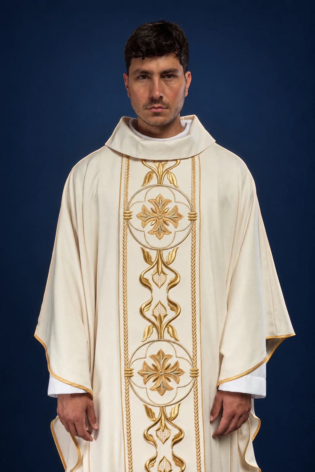 Front view of an ecru chasuble with gold embroidered cross and rosette panel