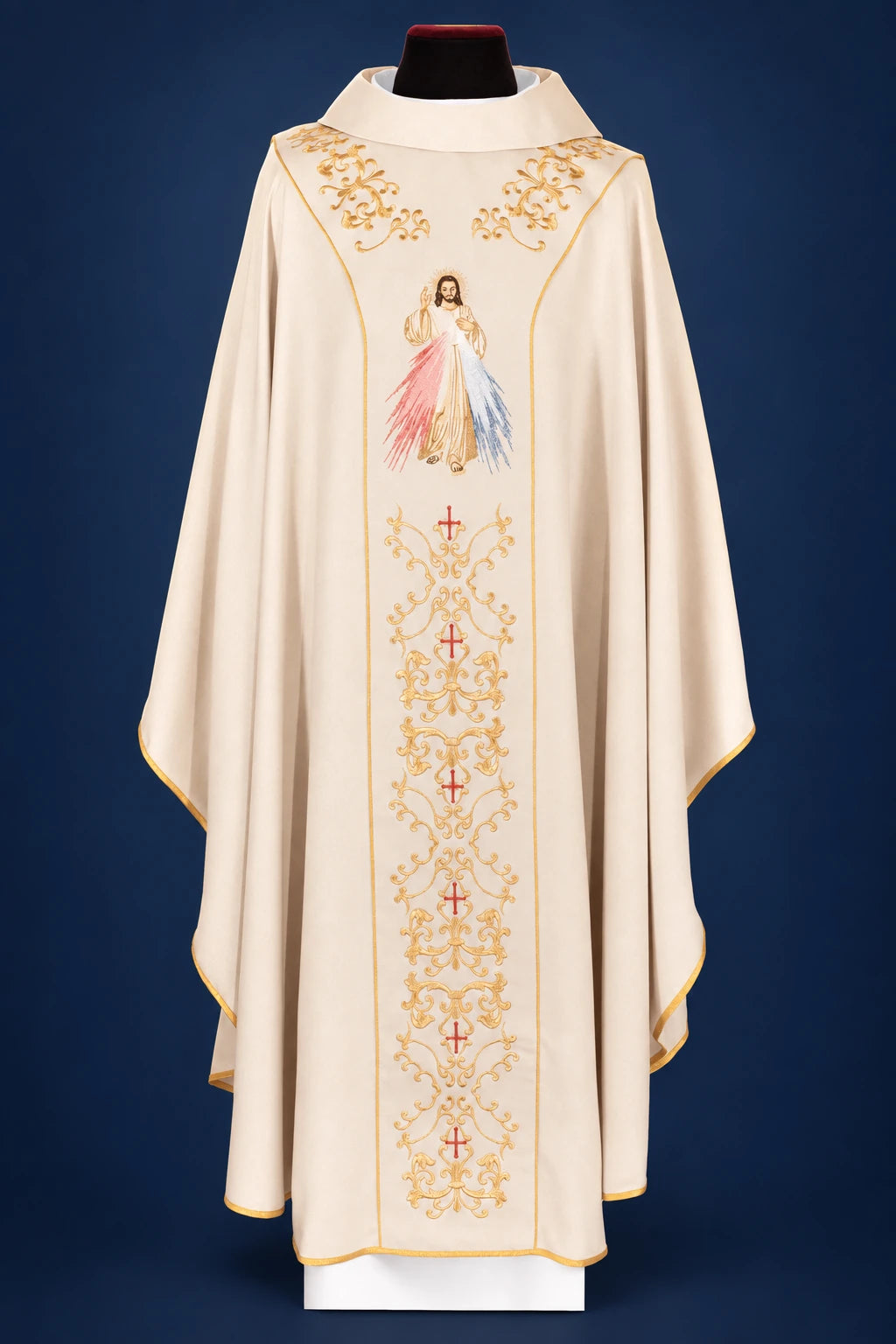 Front view of an ecru chasuble with gold embroidery and a Divine Mercy image on the front panel