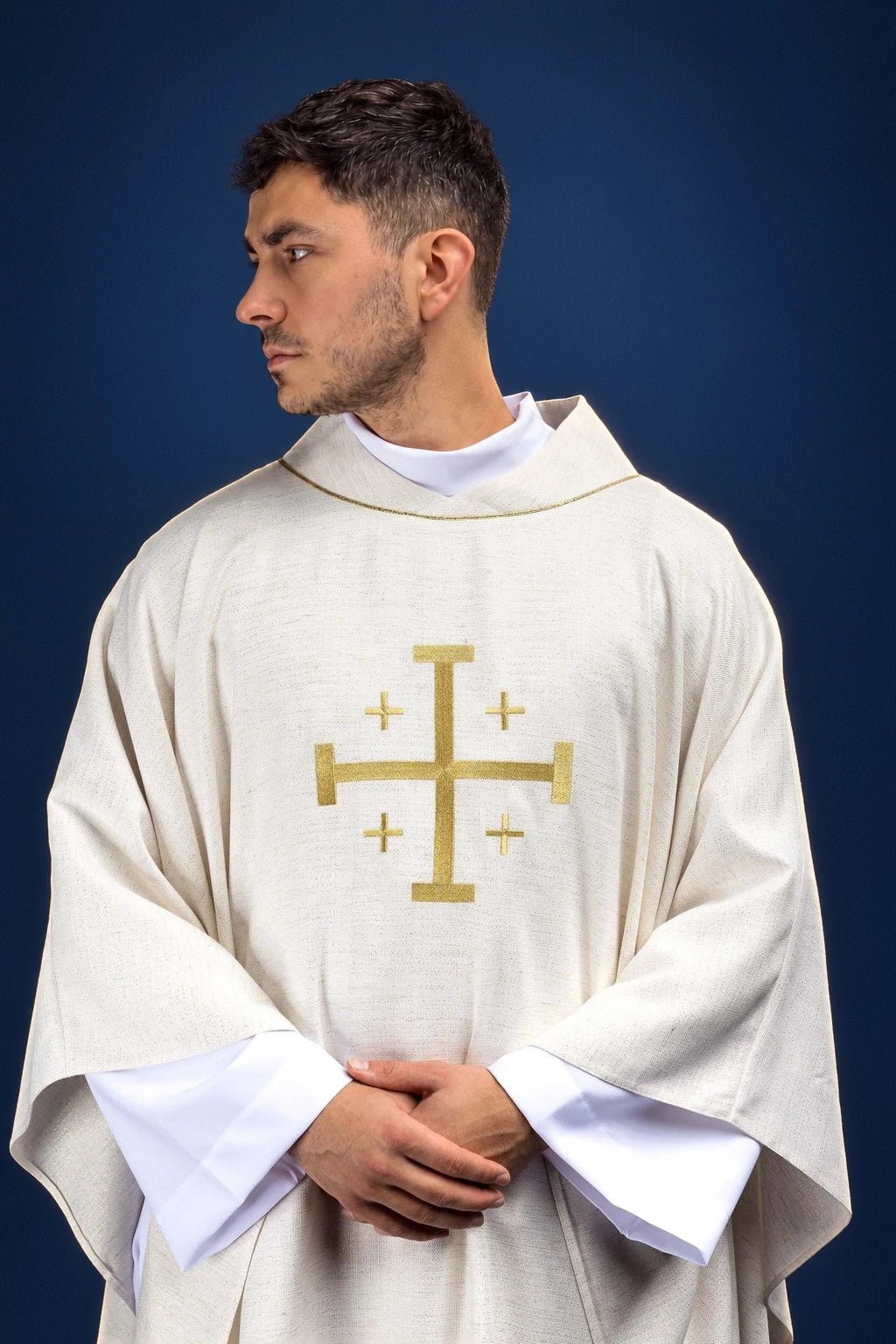 Front view of an ecru chasuble with gold Jerusalem cross embroidery and matching stole collar visible