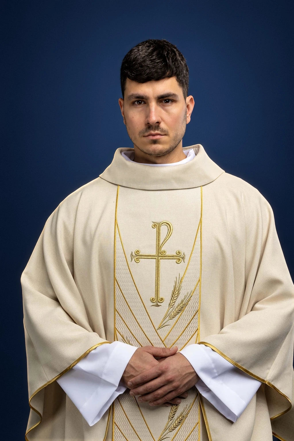Front view of an ecru chasuble with gold PAX embroidery and wheat motif on the orphrey