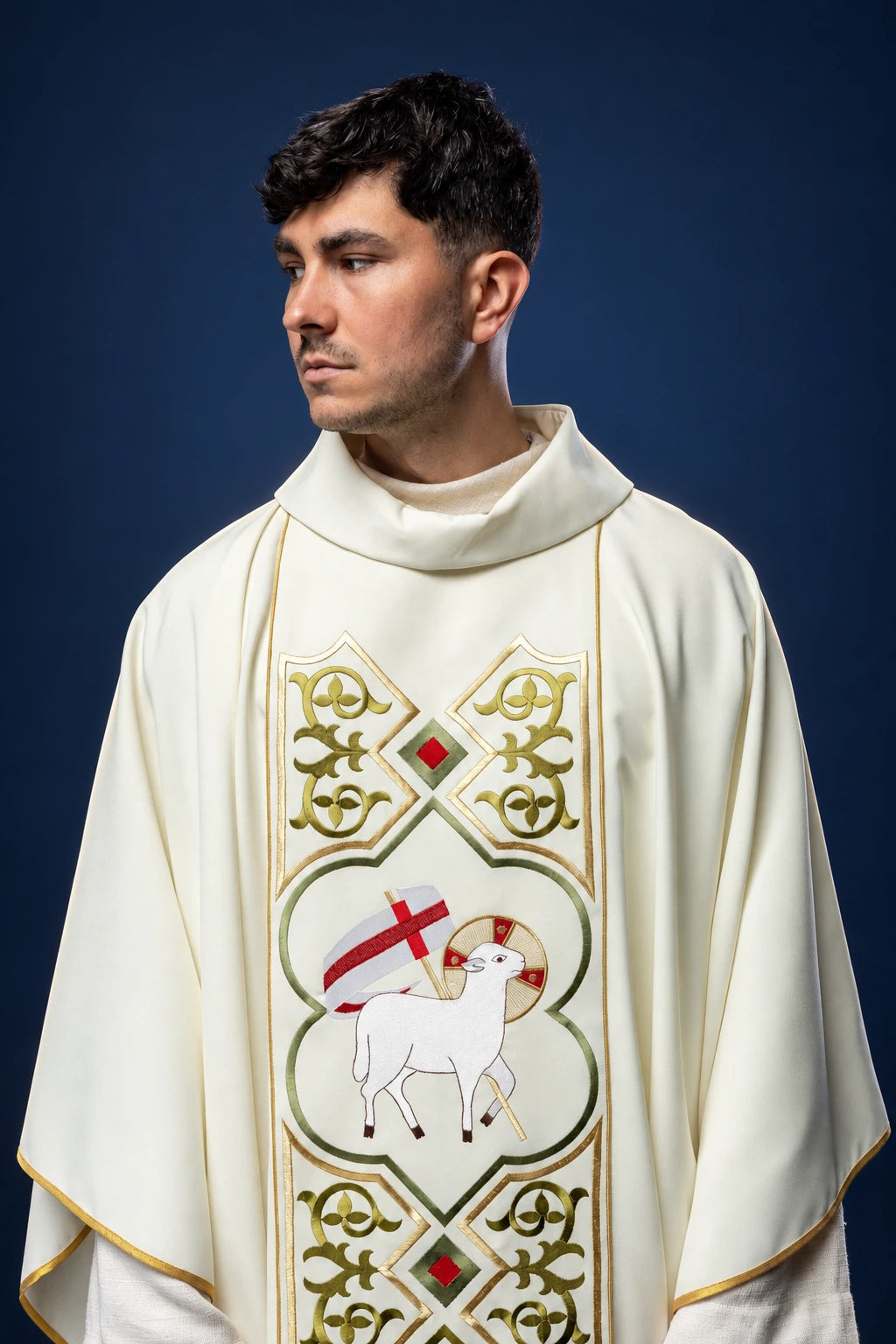 Front view of an ecru chasuble with gold trim and Agnus Dei embroidery on the chest panel