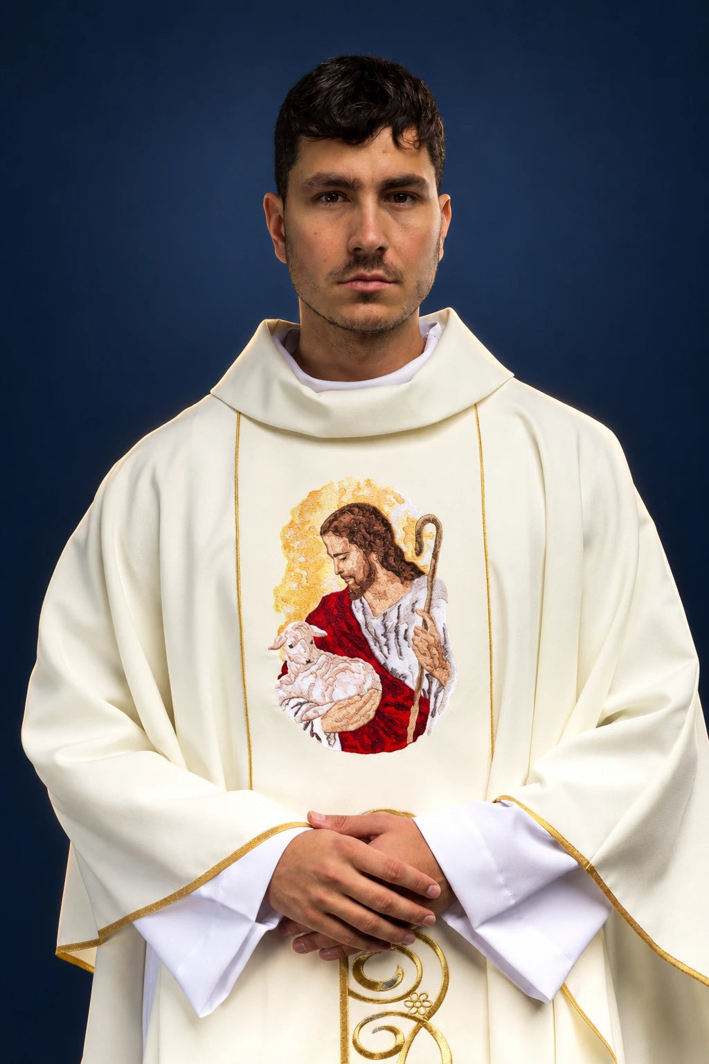 Front view of an ecru chasuble with gold trim and Jesus the Good Shepherd embroidery on the chest