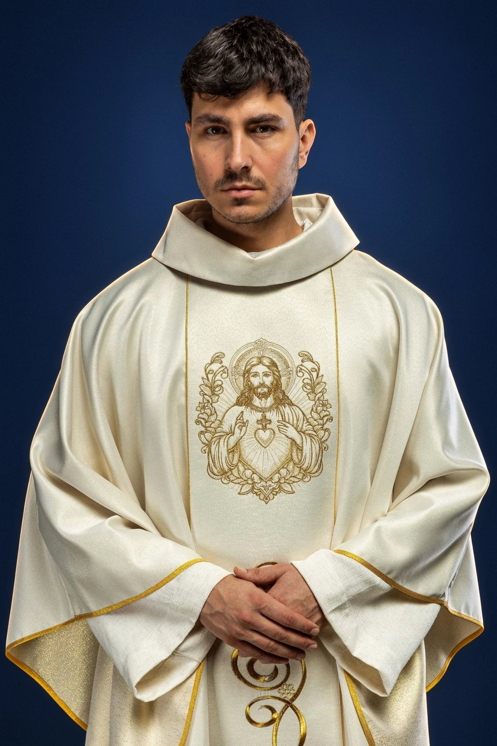 Front view of an ecru chasuble with gold trim and Sacred Heart of Jesus embroidery on the chest