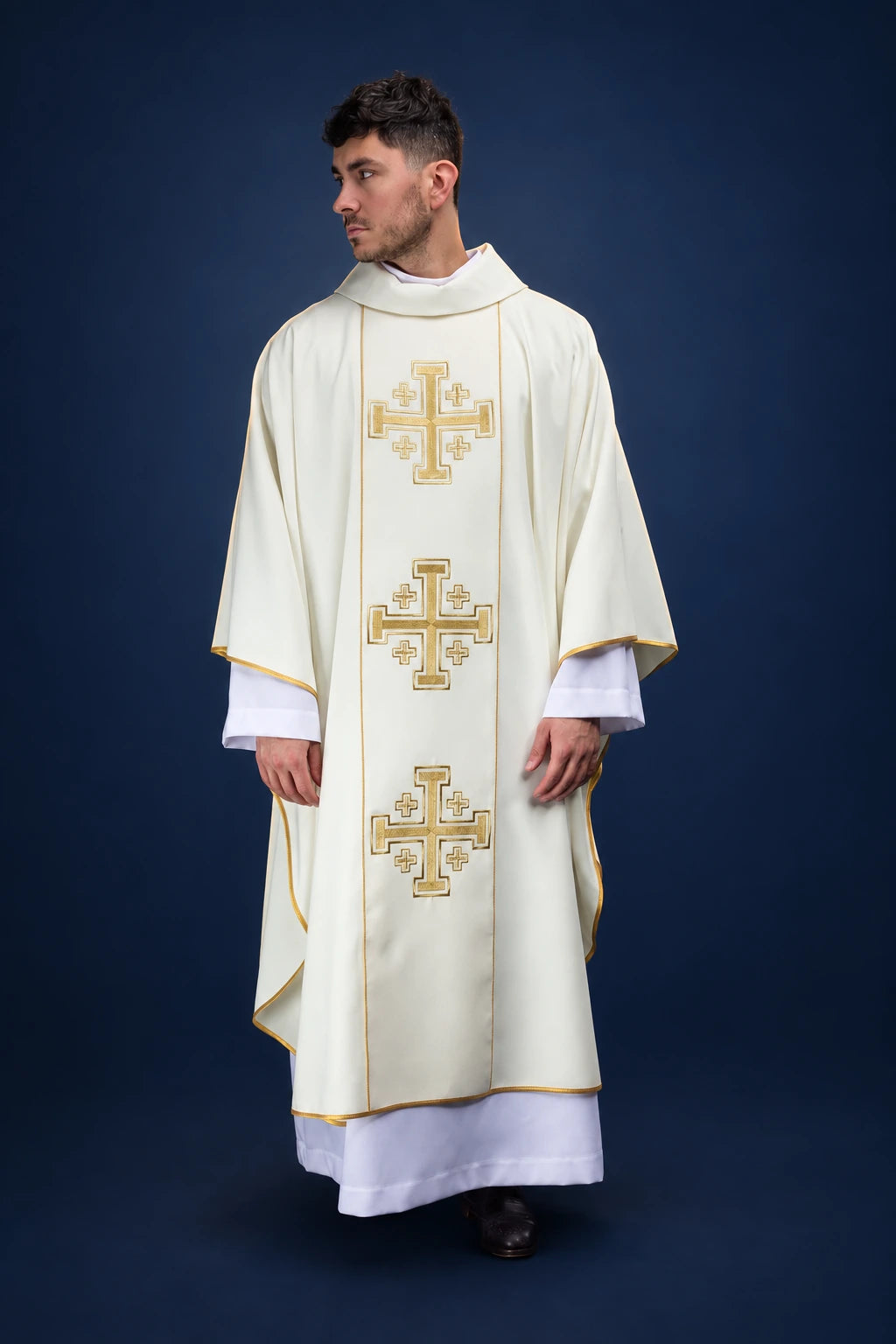 Front view of an ecru chasuble with three embroidered Jerusalem crosses and gold trim