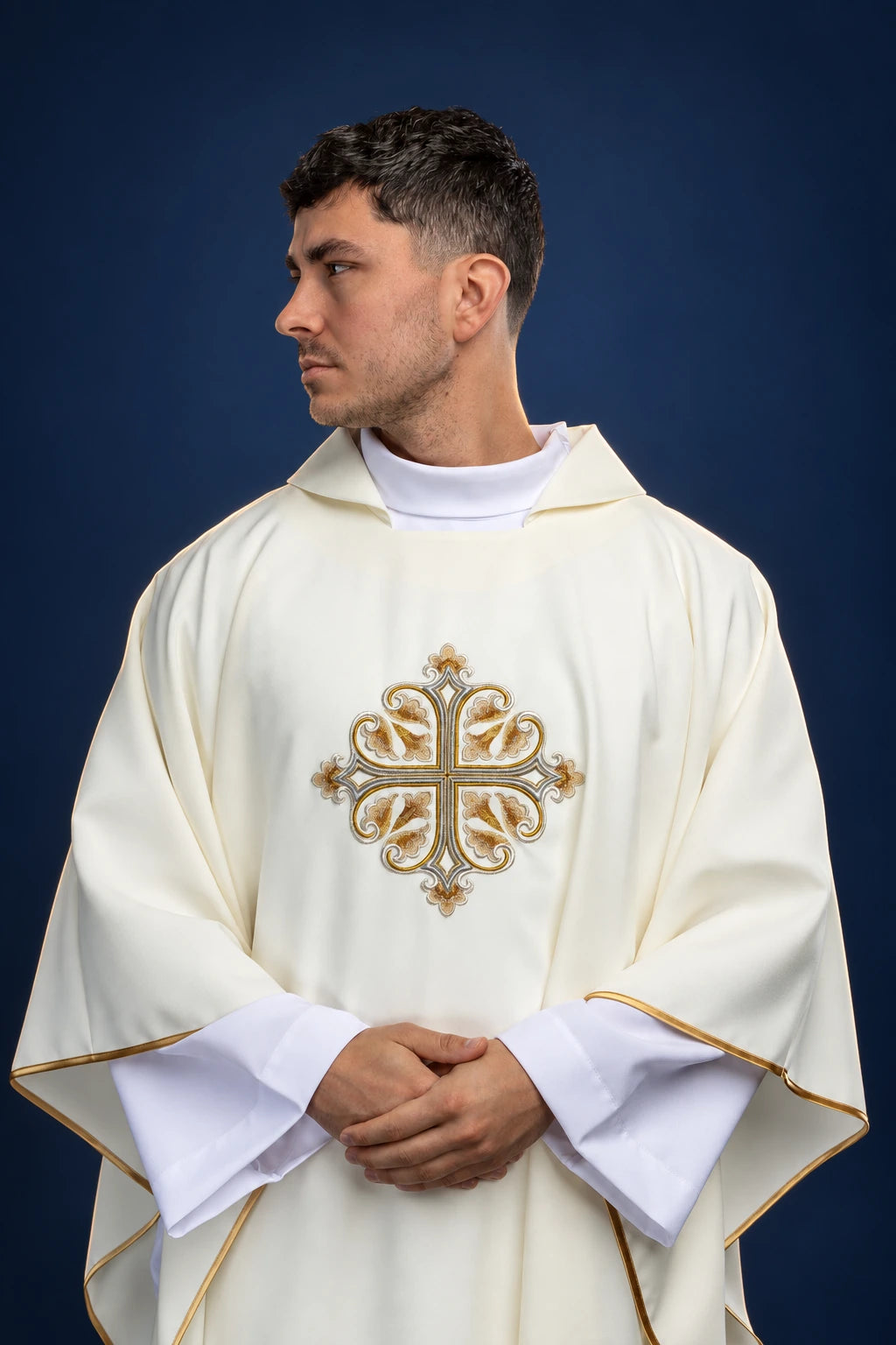 Front view of an ecru chasuble with wide collar and embroidered cross motif on the chest