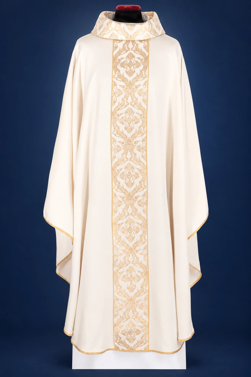 Front view of an ecru chasuble with wide embroidered orphrey and gold trim