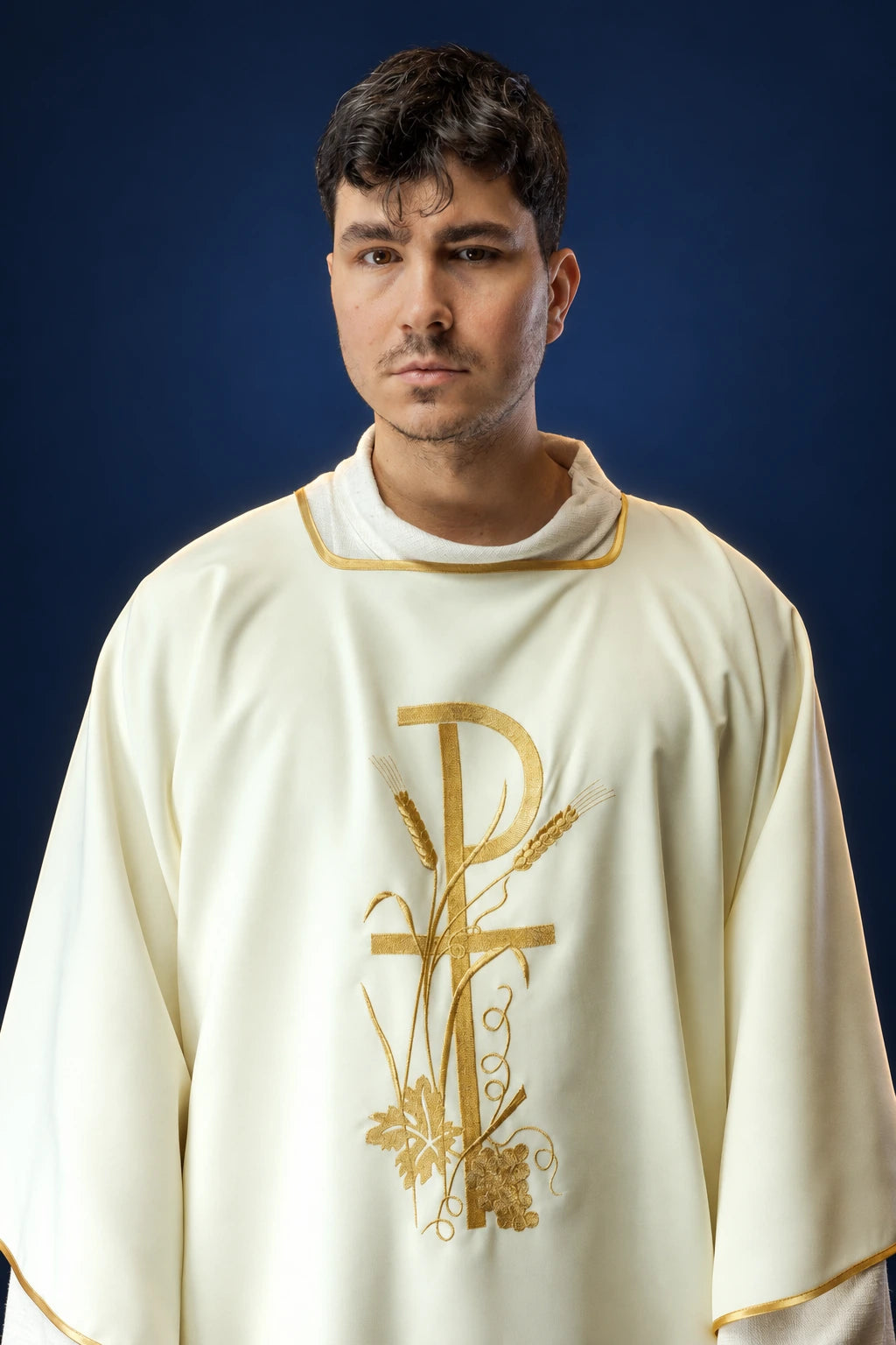 Front view of an ecru dalmatic with gold Pax cross embroidery and gold trim on the sleeves and neckline