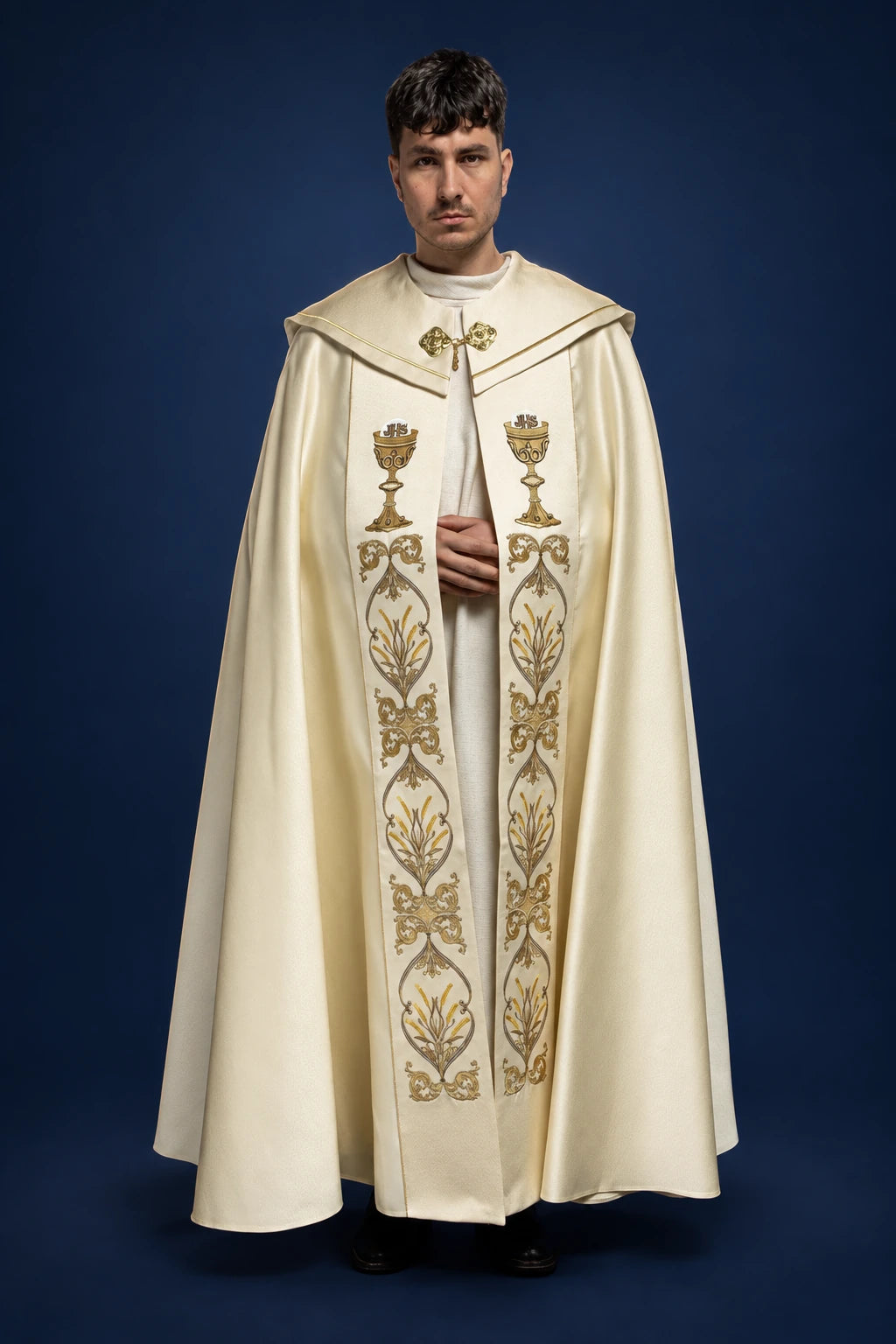 Front view of an ecru liturgical cope with chalice and floral embroidery and a clasp at the neck