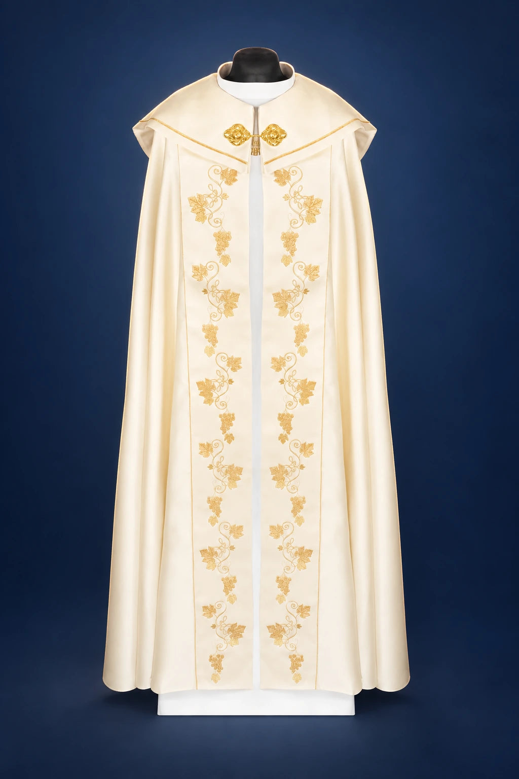 Front view of an ecru liturgical cope with embroidered chalice and IHS motifs down the center and shoulders