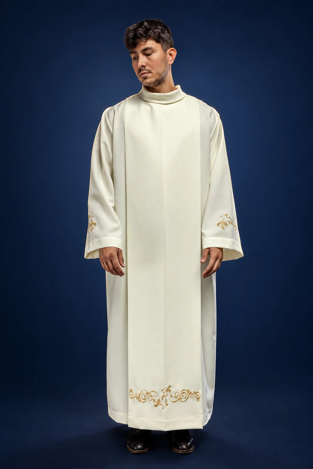 Front view of an ecru priest alb with stand-up collar and gold embroidery at the cuffs and hem