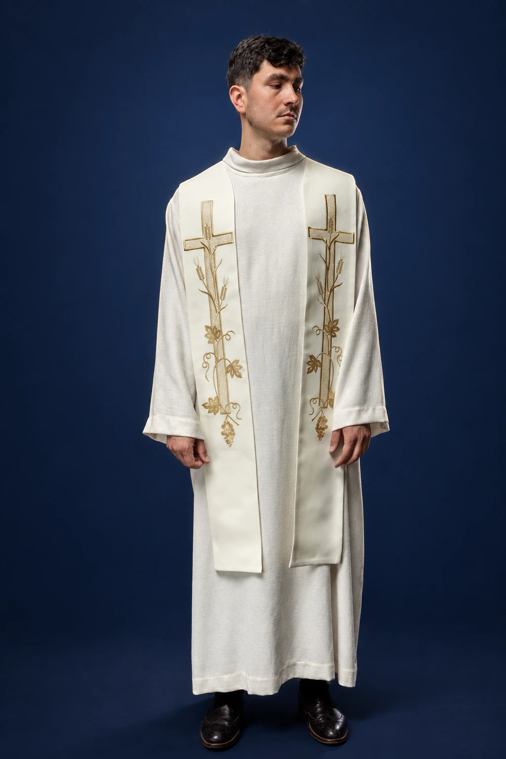 Front view of an ecru priest stole with embroidered crosses and floral vine detail