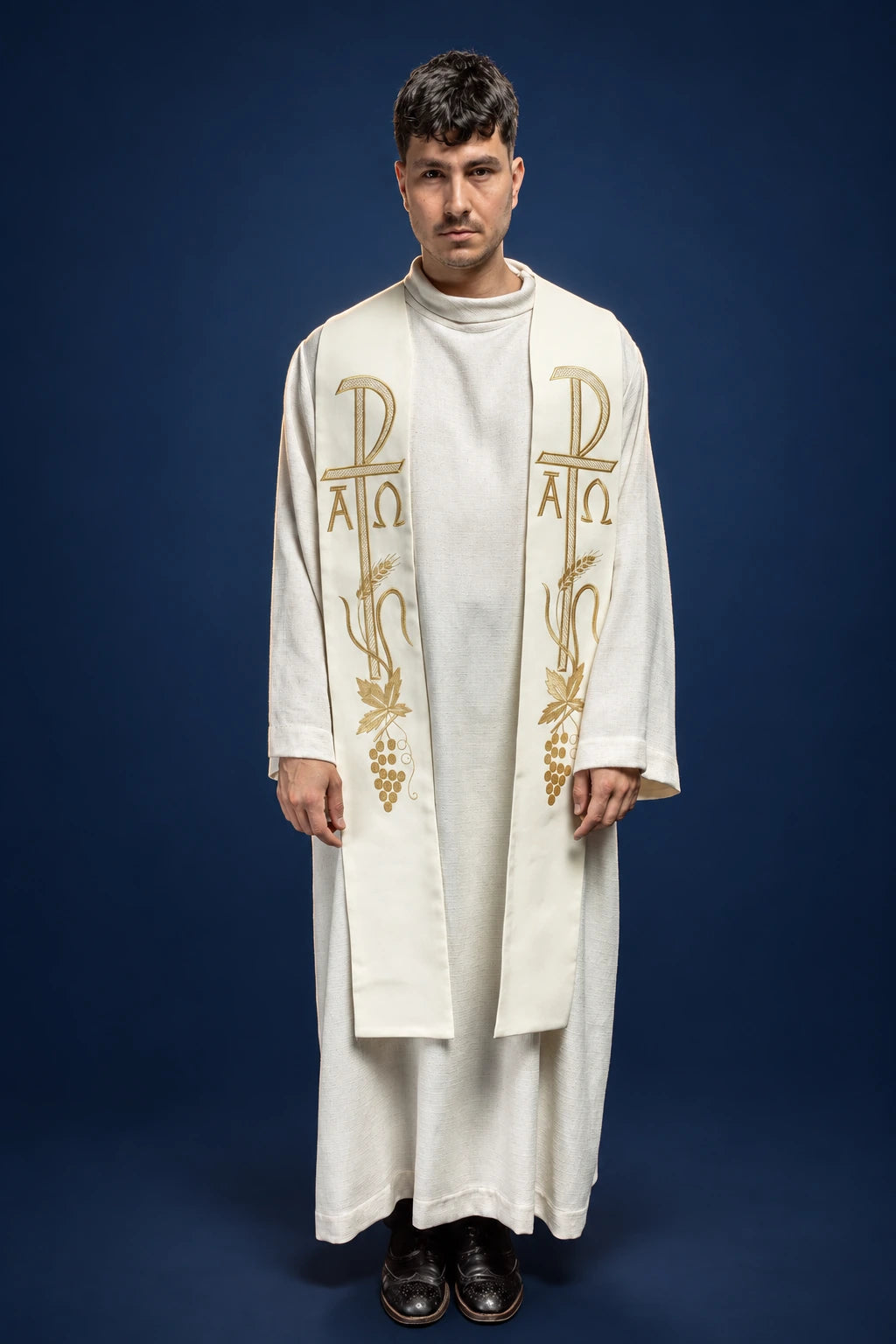 Front view of an ecru priest stole with gold Cross and Alpha Omega embroidery and grapevine motif
