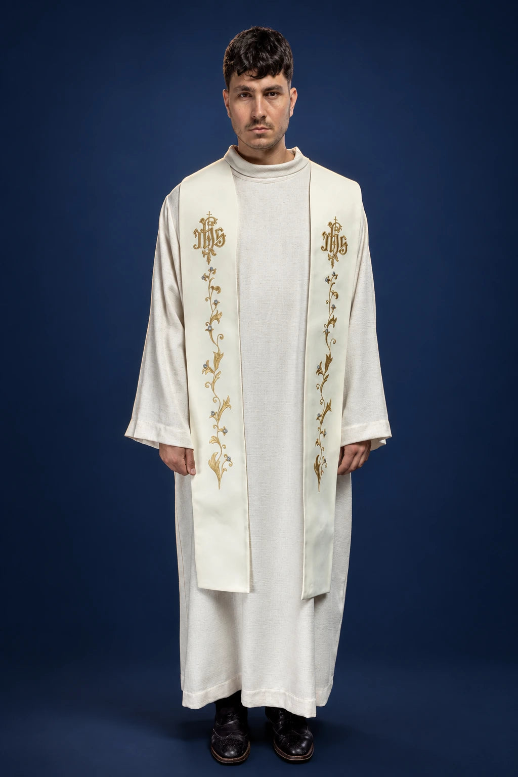 Front view of an ecru stole with gold IHS on a cross and vine embroidery