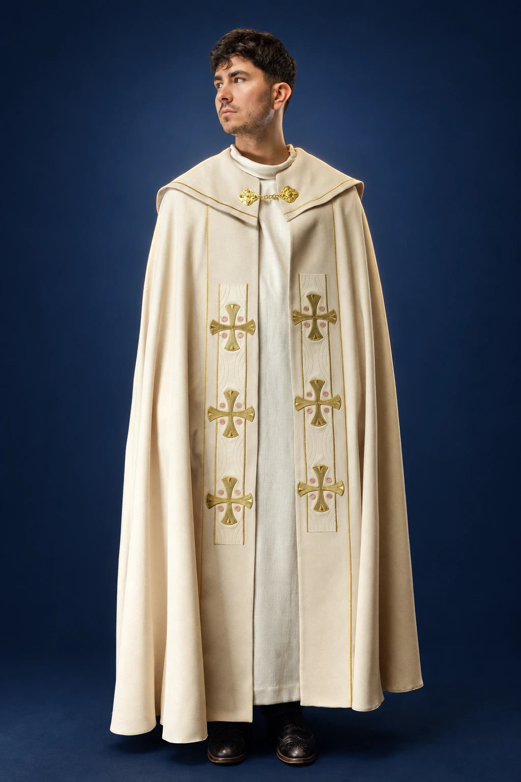Front view of an ecru velvet cope with embroidered gold crosses and gold clasp detail