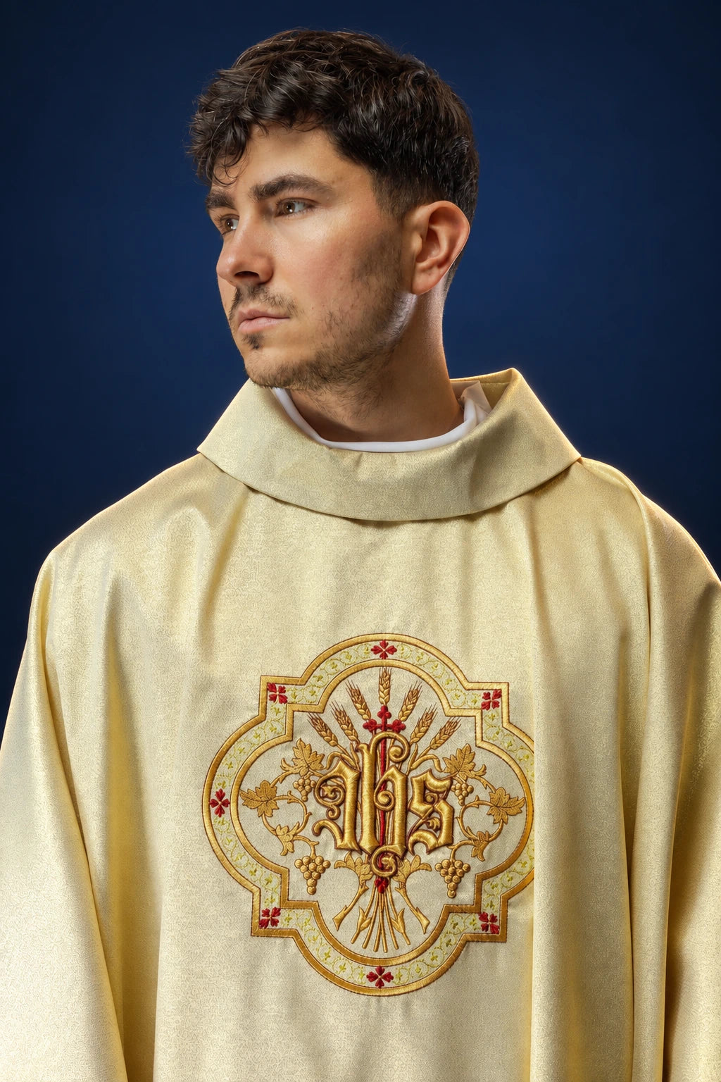 Front view of a gold chasuble with ornate IHS and PAX embroidery on the chest