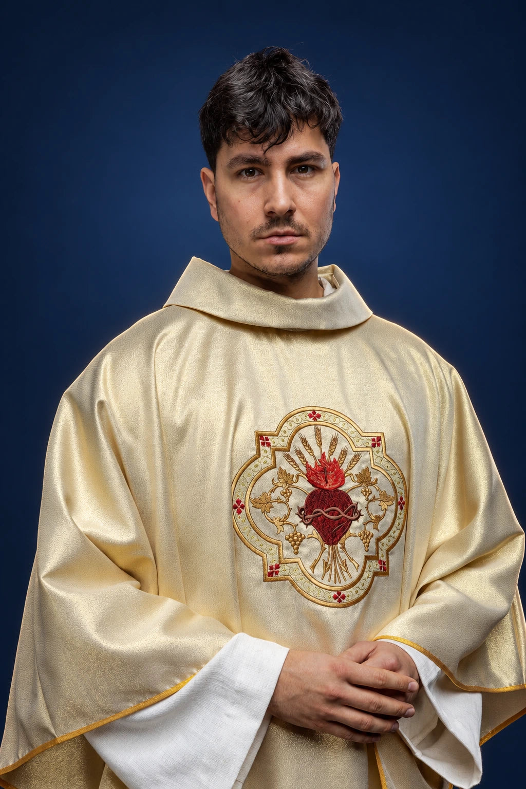 Front view of gold chasuble with Sacred Heart and chalice embroidery on the chest