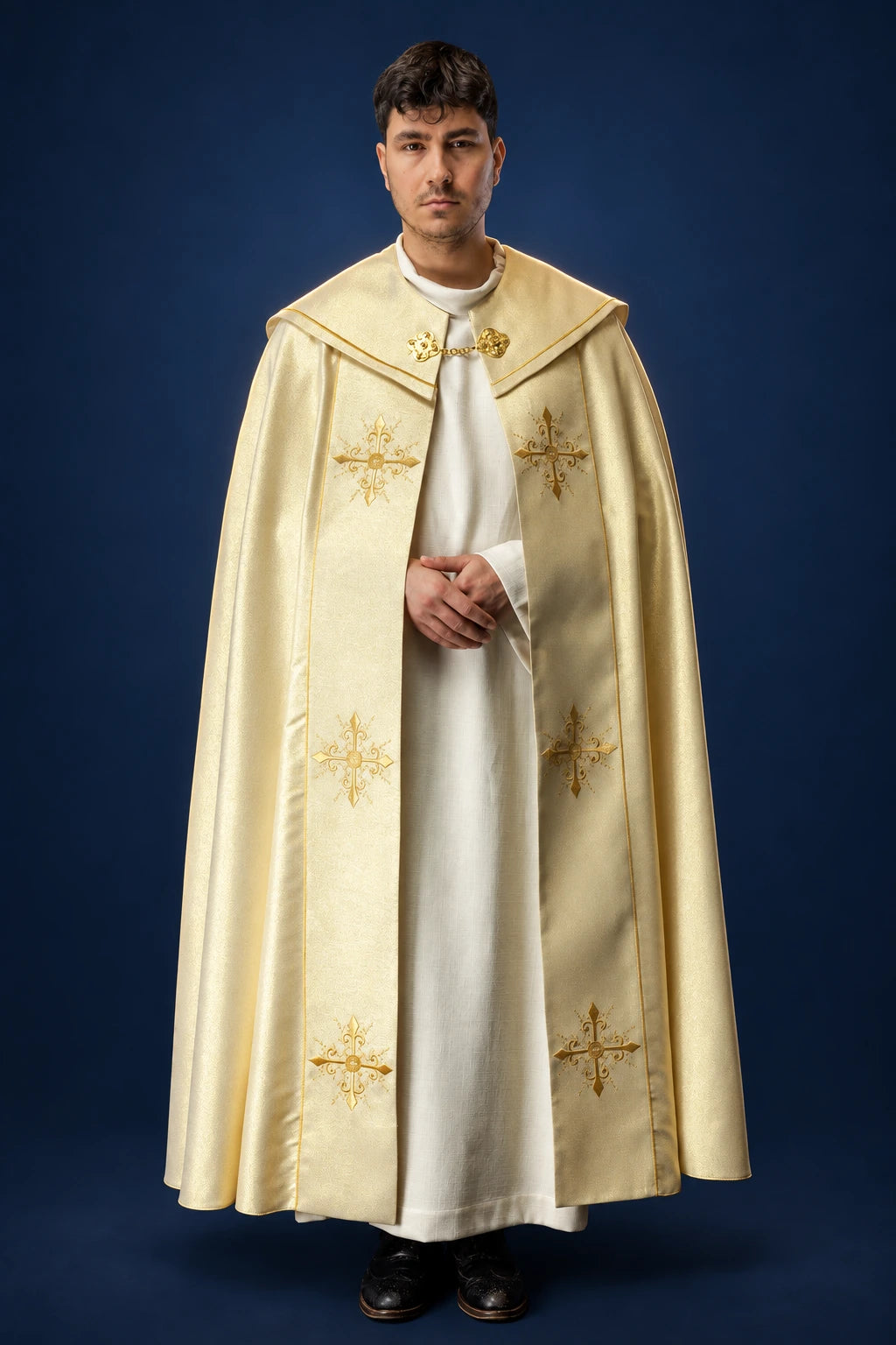 Front view of a gold cope with embroidered cross motifs and clasp at the neck