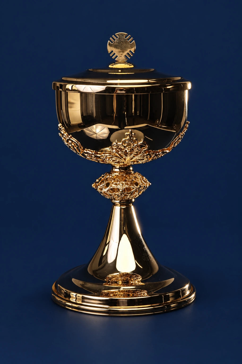 Front view of a gold-plated brass ciborium with ornate stem and round lid finial