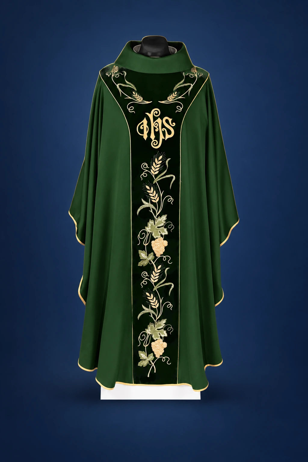 Front view of a green chasuble with black velvet orphrey, IHS embroidery, and vine floral motif