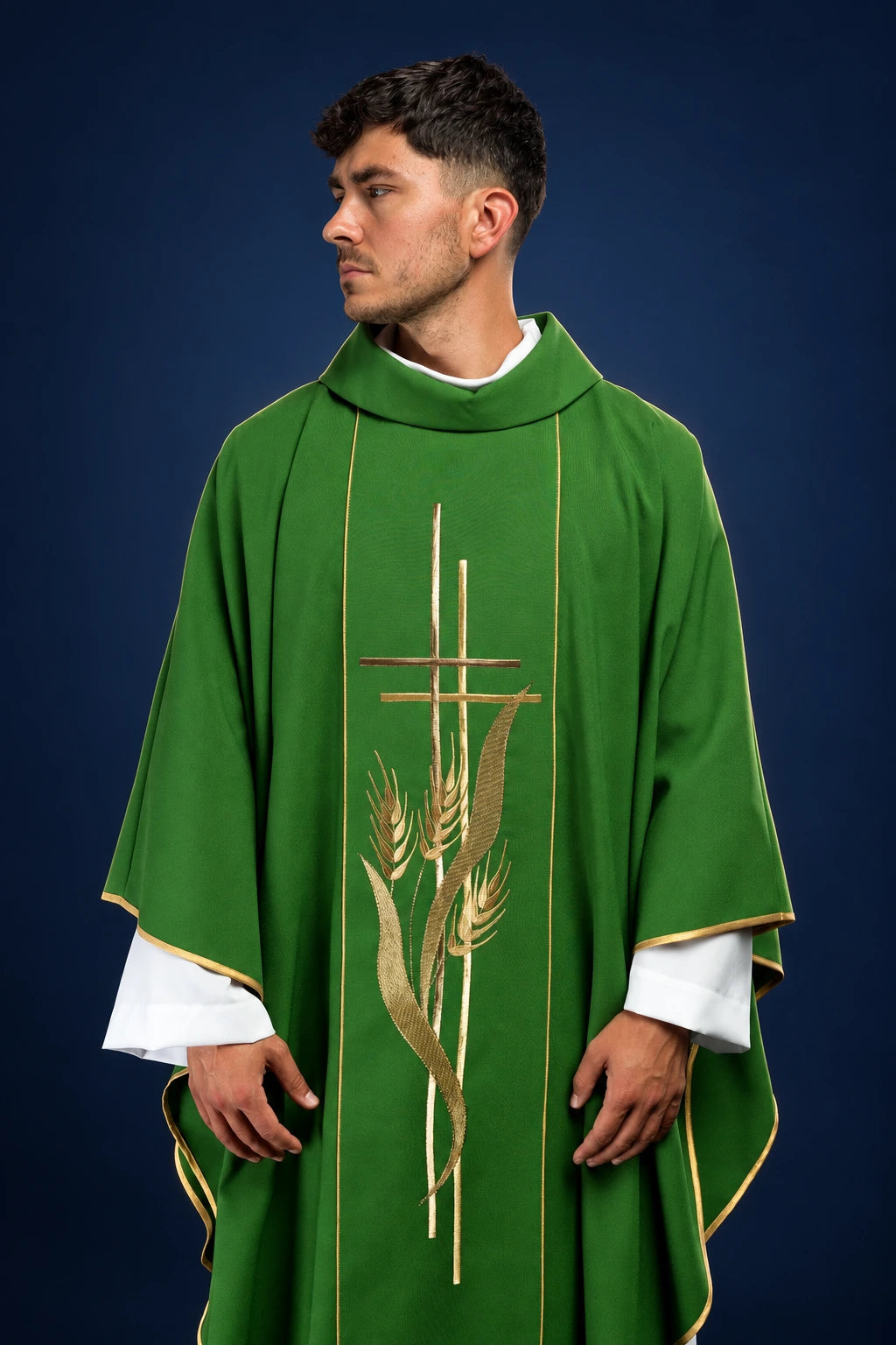 Front view of a green chasuble with gold cross and wheat embroidery and narrow gold trim