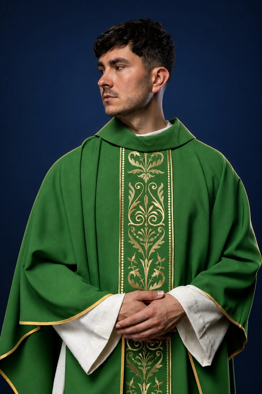 Front view of a green chasuble with a gold embroidered central orphrey and gold trim at the hem and sleeves