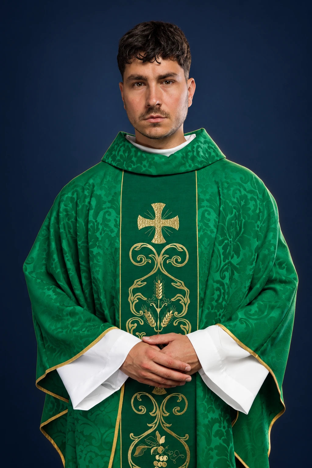 Front view of a green chasuble with gold embroidered orphrey and cross motif, worn over white sleeves