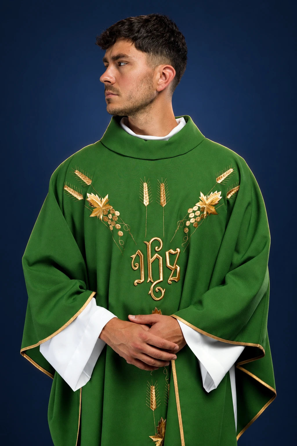 Front view of a green chasuble with gold IHS and grape embroidery and gold trim