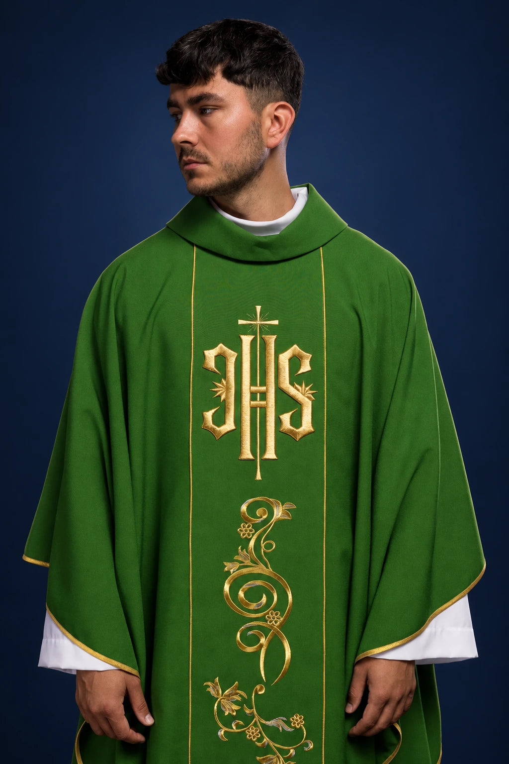 Front view of a green chasuble with gold IHS orphrey and floral embroidery on the center panel
