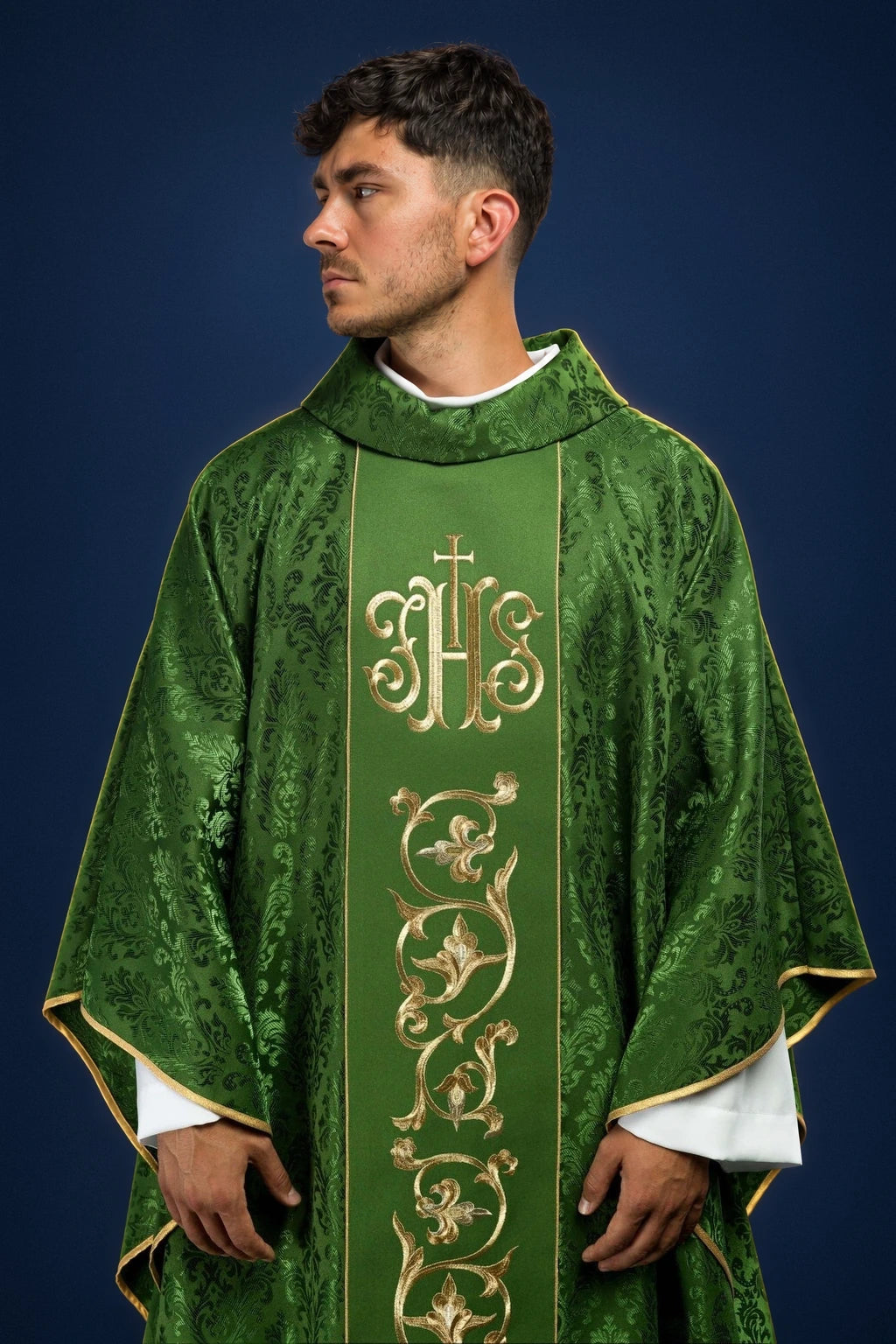 Front view of a green chasuble with gold IHS and vine embroidery down the center orphrey