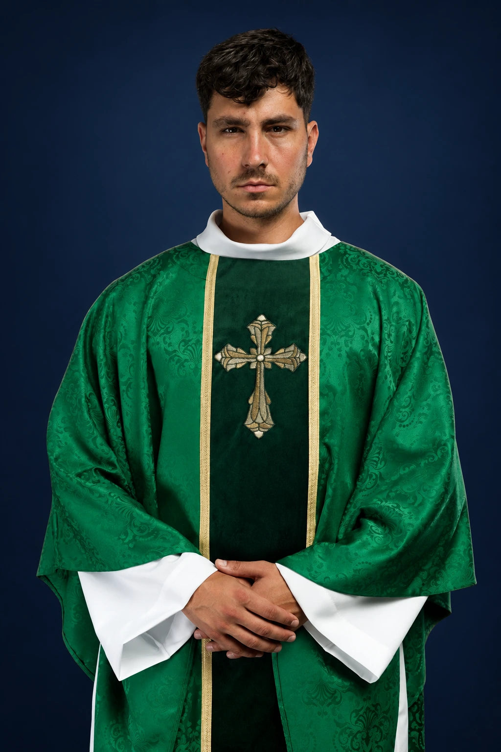 Front view of a green chasuble with gold orphrey and embroidered cross on the chest