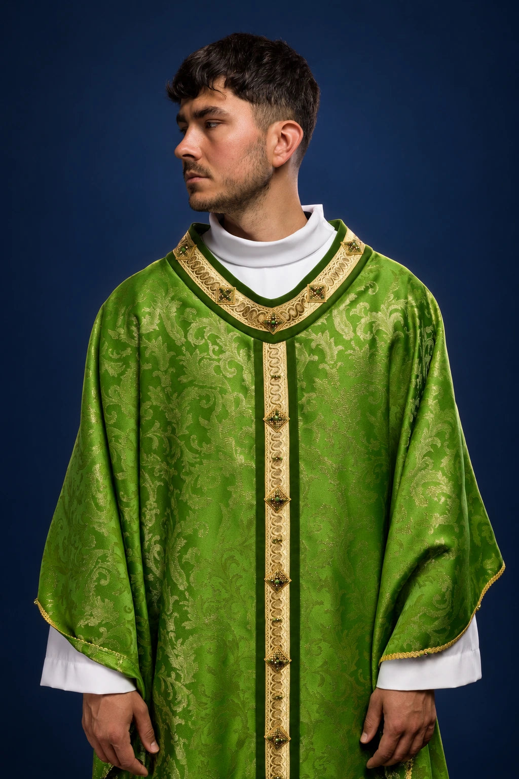 Front view of a green chasuble with gold trim and a vertical central band with stone-like accents
