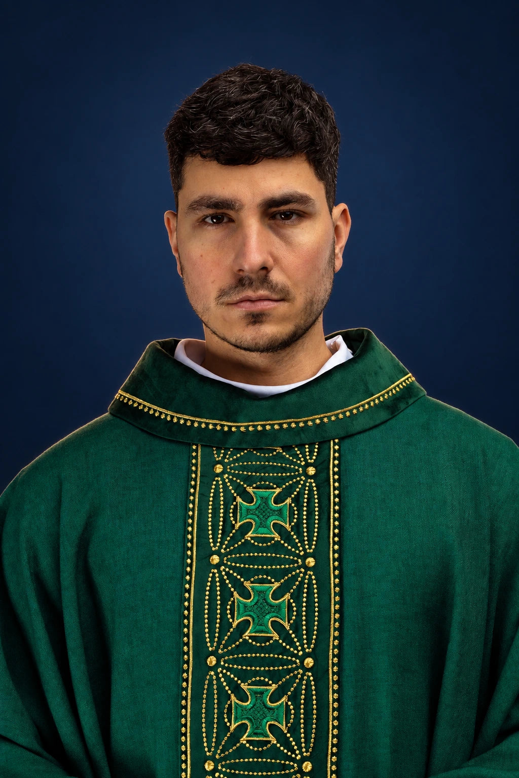 Front view of a green chasuble with ornate vertical cross orphrey and gold dot trim