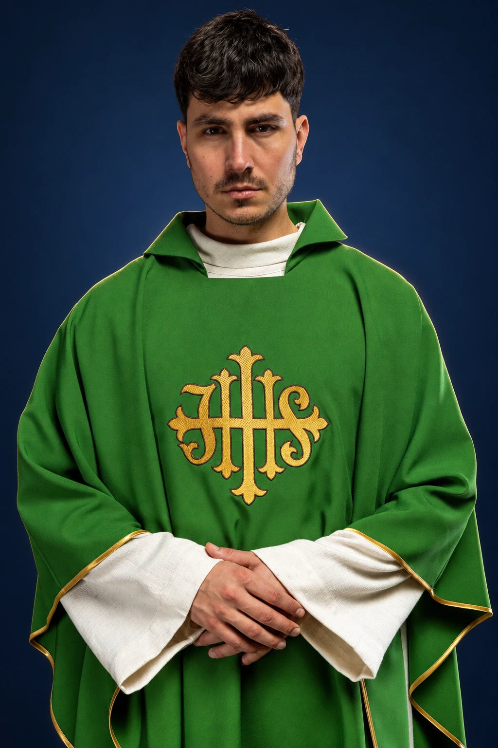 Front view of a green chasuble with wide collar and gold JHS emblem on the chest