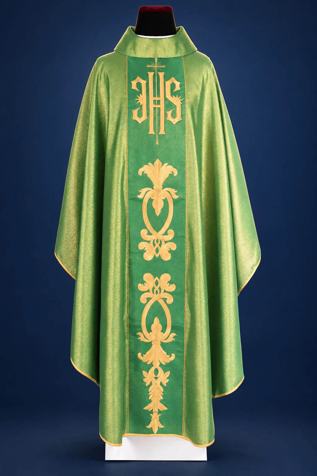 Front view of a green chasuble with wide orphrey and gold IHS and floral motif