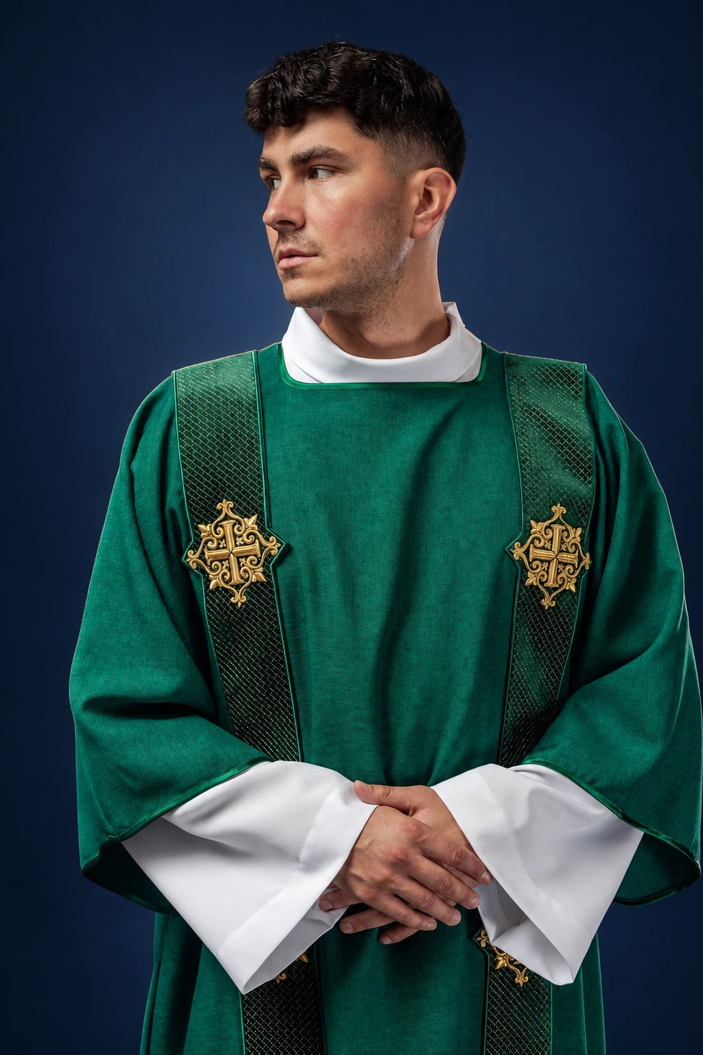 Front view of a green dalmatic with cross motifs and narrow orphrey bands on the shoulders and front